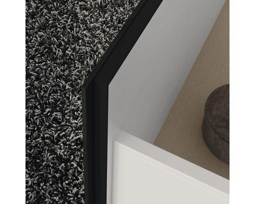 Detailaufnahme eines Badezimmers mit Teppich, Waschbeckenunterschrank und Ablagefläche