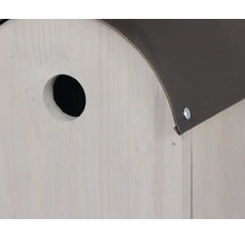 Detailaufnahme eines Vogelhauses mit Einflugloch und Dach