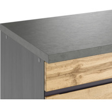 Detailansicht eines Badezimmermöbels mit grauer Platte und Holzfront