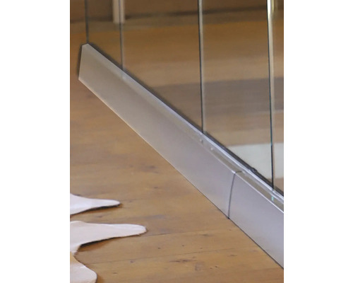 Detailaufnahme einer Duschkabine mit Metalleinfassung auf einem Holzboden