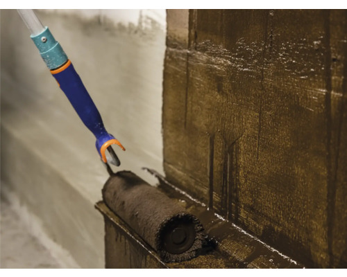 Eine Wand wird mit einer Walze gestrichen.