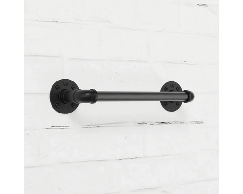 Schwarzer Toilettenpapierhalter aus Metall im industriellen Stil an einer Ziegelwand