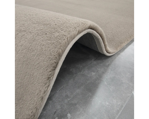 Detailansicht eines beigen Teppichs mit hochflorigem Flor