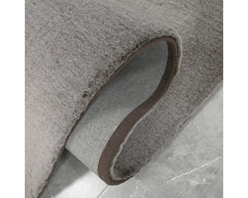 Grauer Teppich mit gekräuselter Ecke