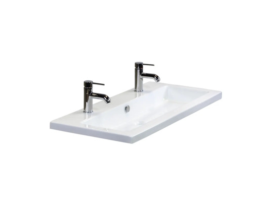 Weißes Keramikwaschbecken mit zwei Armaturen