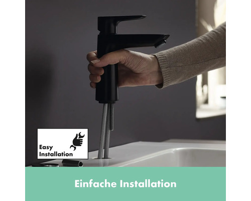 Eine Hand hält einen schwarzen Wasserhahn über einem Waschbecken zur einfachen Installation