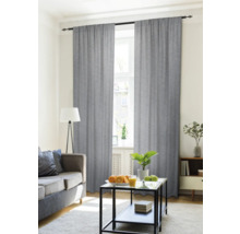 Wohnzimmer mit Vorhängen vor dem Fenster, Sofa und Tisch