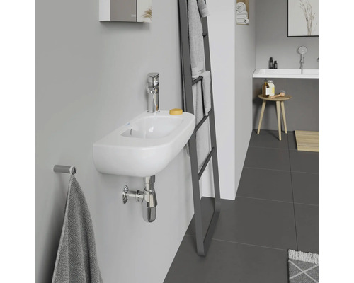 Modernes Badezimmer mit kleinem Waschbecken an der Wand, Armatur, Handtuchhalter und Handtuchleiter