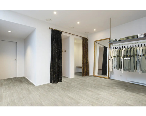 Innenraum eines Bekleidungsgeschäfts mit Umkleidekabinen, Spiegel und Kleiderstange