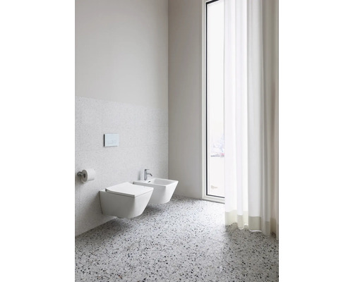 Helles Badezimmer mit wandhängendem WC, Bidet und Fenster