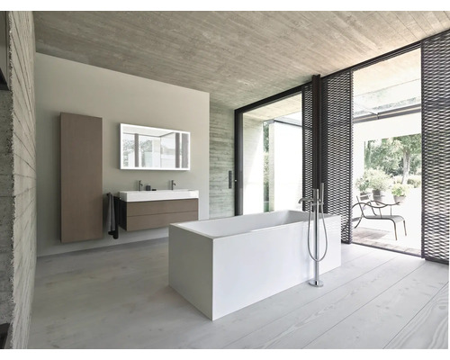 Helles Badezimmer mit Badewanne, Waschtisch, Spiegel und Zugang zum Außenbereich