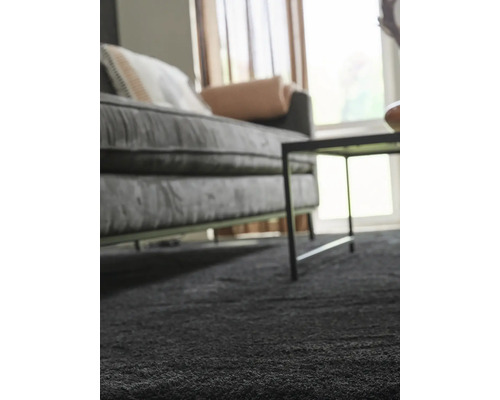 Wohnzimmer mit Sofa, Tisch und Teppich