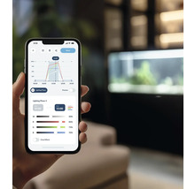 Ein Smartphone zeigt eine App zur Steuerung von Aquarienbeleuchtung mit Diagrammen und Einstellungen.