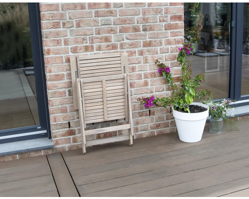 Zusammengeklappter Holzklappstuhl auf einer Terrasse
