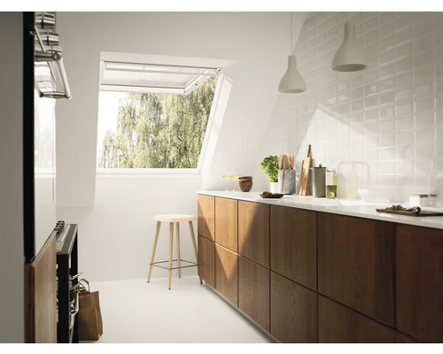 Helle Küche mit Dachfenster, Holzschränken, Küchenutensilien und Hocker.