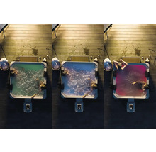 Drei Whirlpools mit farbig beleuchtetem Wasser auf einer Holzterrasse, von oben aufgenommen.