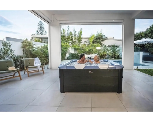 Außenbereich mit Whirlpool und zwei Personen, die anstoßen