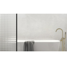 Modernes Badezimmer mit freistehender Badewanne, goldener Armatur und strukturierten Fliesen