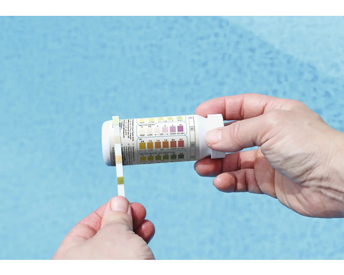 Person misst den pH-Wert des Pools mit Teststreifen