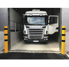Ein Lastwagen der Marke Scania fährt in ein Gebäude.