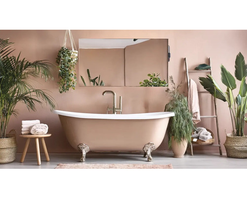 Badezimmer mit freistehender Badewanne, Spiegel und Pflanzen für eine entspannende Atmosphäre