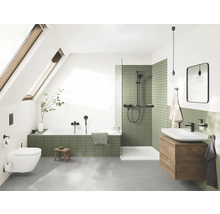Badezimmer mit Badewanne, Dusche, Waschbecken und Toilette unter einem Dachfenster