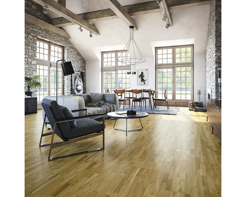 Heller Wohnraum mit Holzboden, Sofa, Sessel und Esstisch unter einer modernen Hängelampe.
