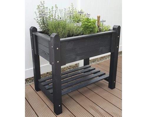 Hochbeet aus Holz mit Kräutern und Ablagefläche