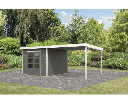 Gartenhaus mit Anbau auf Pflastersteinen vor Bäumen