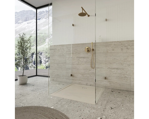 Begehbare Dusche mit Kopfbrause, Duschwanne und Glasabtrennung in einem hellen Badezimmer.