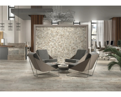 Ein heller Büroraum mit Mosaikwand, Sesseln und Arbeitsplätzen.