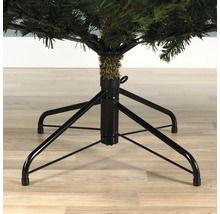 Detailaufnahme eines künstlichen Weihnachtsbaums mit schwarzem Metallständer