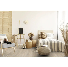 Helles Kinderzimmer mit Bett, Sessel, Staffelei und Spielzeugpuppen