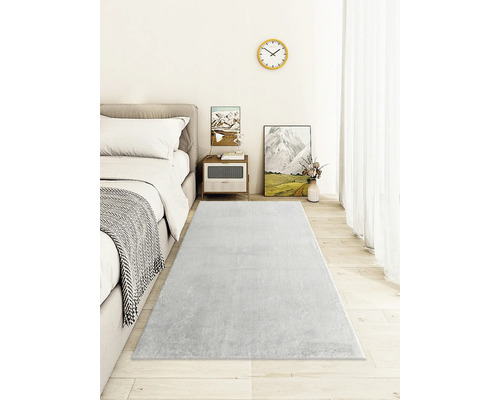 Heller Teppich im Schlafzimmer mit Bett und Nachttisch