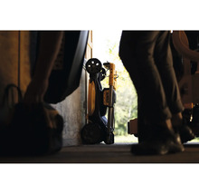 Zusammengeklappter DeWalt Arbeitsstrahler mit Transporträdern, aufbewahrt in einer Werkstatt