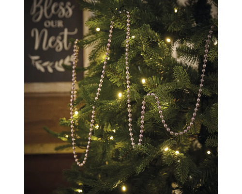 Dekorierter Weihnachtsbaum mit Kugelkette und Lichterkette