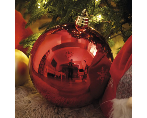 Rote Weihnachtskugel unter einem Weihnachtsbaum