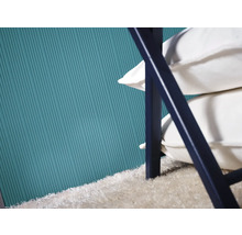 Detailansicht von blauer Wand, Teppich und Stuhl