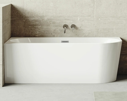 Eckbadewanne Jungborn One links 169x76 cm weiß Rechteckige Badewanne aus Sanitäracryl mit Armaturen an einer Betonwand