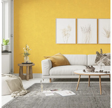 Wohnzimmer mit weißem Sofa, gemustertem Teppich und gelber Wand