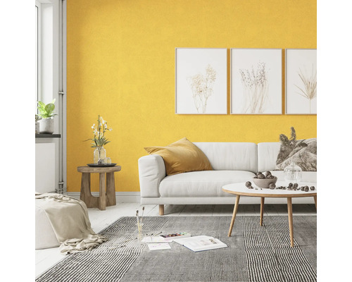 Wohnzimmer mit weißem Sofa, gemustertem Teppich und gelber Wand