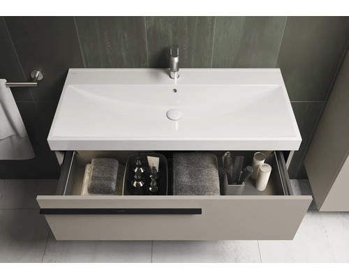 Waschtischunterschrank mit geöffneter Schublade, Waschbecken, Armatur und Badutensilien.