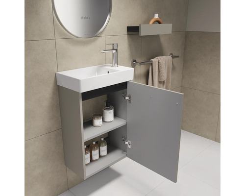 Badezimmer mit Waschbeckenunterschrank, Armatur, Spiegel und Handtuchhalter
