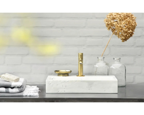 Modernes Badezimmer mit Marmorwaschbecken, goldener Armatur und Seifenschale
