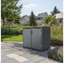 Graue Mülltonnenbox mit zwei Türen im Garten auf Steinboden