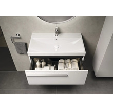 Badezimmer Waschbeckenunterschrank mit geöffneter Schublade, darin Handtücher und Badutensilien.