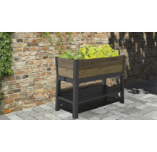 Hochbeet mit Ablagefläche und Bepflanzung vor einer Ziegelmauer