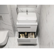 Modernes Badezimmer mit Waschbecken, Unterschrank und geöffneter Schublade für Badutensilien