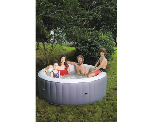 Familie entspannt in einem aufblasbaren Whirlpool im Garten.