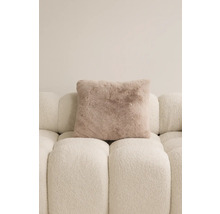Quadratisches Zierkissen mit Felloptik auf einem Sofa.